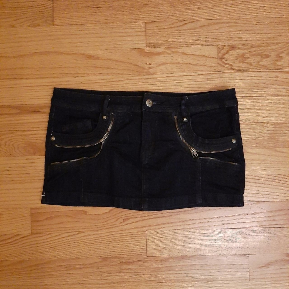 Darkwash denim micro skirt with zipper detailing and stud embellishments